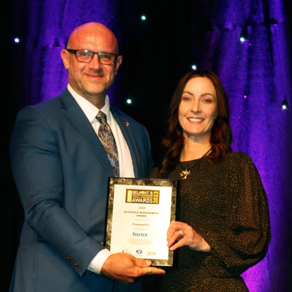 ProposalPro's principal consultant Roz Misiani accepting the Business Managemnent award from sponsor Paul Faix.